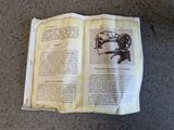 an open book with a picture of a sewing machine on it