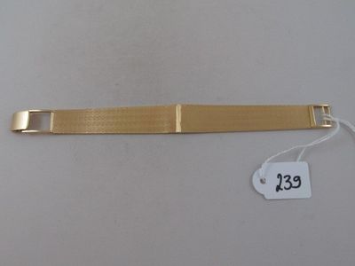 a close up of a gold bracelet with a price tag on it