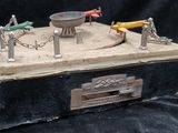 a small box with a bunch of miniature figurines on top of it