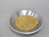 a metal bowl with a dough in it on a table