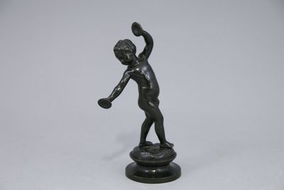 statue of a boy with a tennis racket in his hand