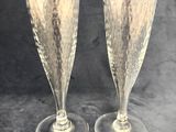 two champagne glasses sitting next to each other on a table