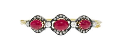 a close up of a ring with two red stones on it