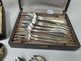 a lot of silverware in a case on a table
