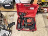 a red tool box with tools in it on the floor