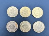 six pièces britanniques différentes, dont une de une livre et une de une livre