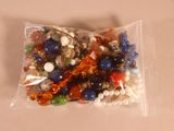 un sac de perles et des perles posées sur une table