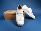 a pair of white shoes sitting on top of a box