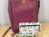 a bag and wallet sitting on a table next to a purse