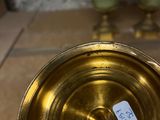 a gold plate with a tag on it sitting on a table