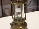 a small brass lantern sitting on a white table