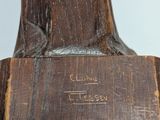 an image of a wooden sculpture of a man on a horse