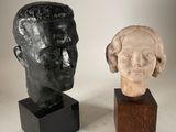 deux sculptures représentant une tête d'homme et une tête de femme