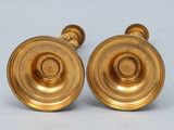 pair of antique brass candlesticks on a white background