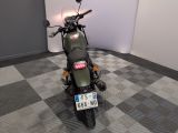 a motorcycle that is parked in a room with a checkered floor