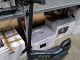 a scooter that is sitting on the floor in front of boxes