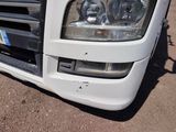 a close up of a white truck parked on the side of the road