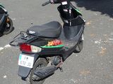 a scooter parked in a parking lot with other scooters