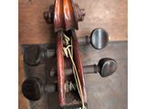 a violin that is sitting on a wooden table