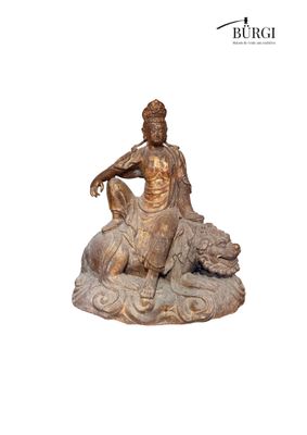 statue of a man sitting on a rock with a dog