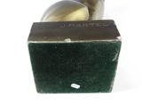 a metal object that is sitting on top of a green box
