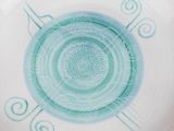a white plate with a blue design on it