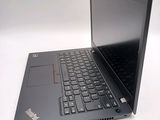 a laptop with a black keyboard sitting on a white surface