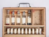 a wooden case with bottles of medicine in it