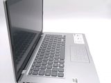 a silver laptop computer sitting on top of a white table