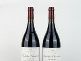 deux bouteilles de vin rouge posées l'une à côté de l'autre sur une surface blanche