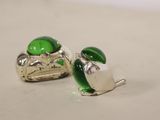 pair of green glass and silver plated cufflinks on a white surface