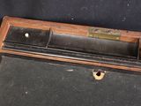a black suitcase with a wooden handle on a black background