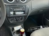 a car dashboard with a bottle of beer in it