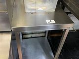 a metal table with a plastic container on top of it