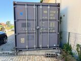 a large gray container sitting on the side of a building