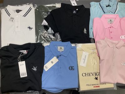 a lot of polo shirts that are sitting on a table