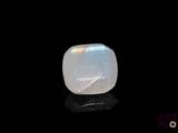 a white moons stone sitting on top of a black surface