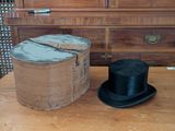 a hat and a top hat sitting on a wooden table