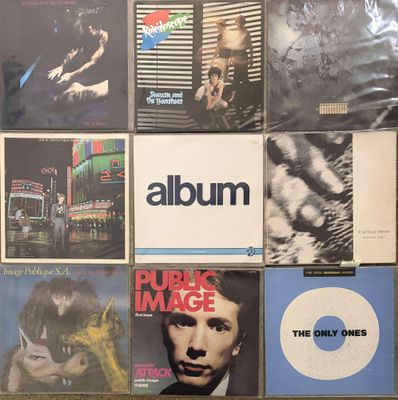 a lot of album covers on the wall of a room