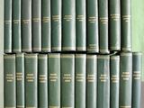 many books stacked on top of each other on a shelf