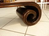 a wooden table with a roll of wood on it