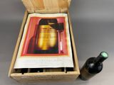 a bottle of wine in a wooden box next to a bottle of wine