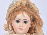 a doll that is wearing a dress and a necklace