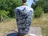 a blue and white vase sitting on top of a table