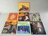 several albums of the beatles are sitting on a table