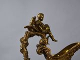 a gold statue of a man sitting on top of a boat