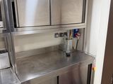 a kitchen with stainless steel cabinets and appliances in it