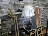 a desk with a lamp and a laptop on it