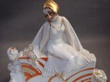 a figurine of a woman sitting on a horse