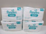 three packs of pampers pants sitting on top of each other